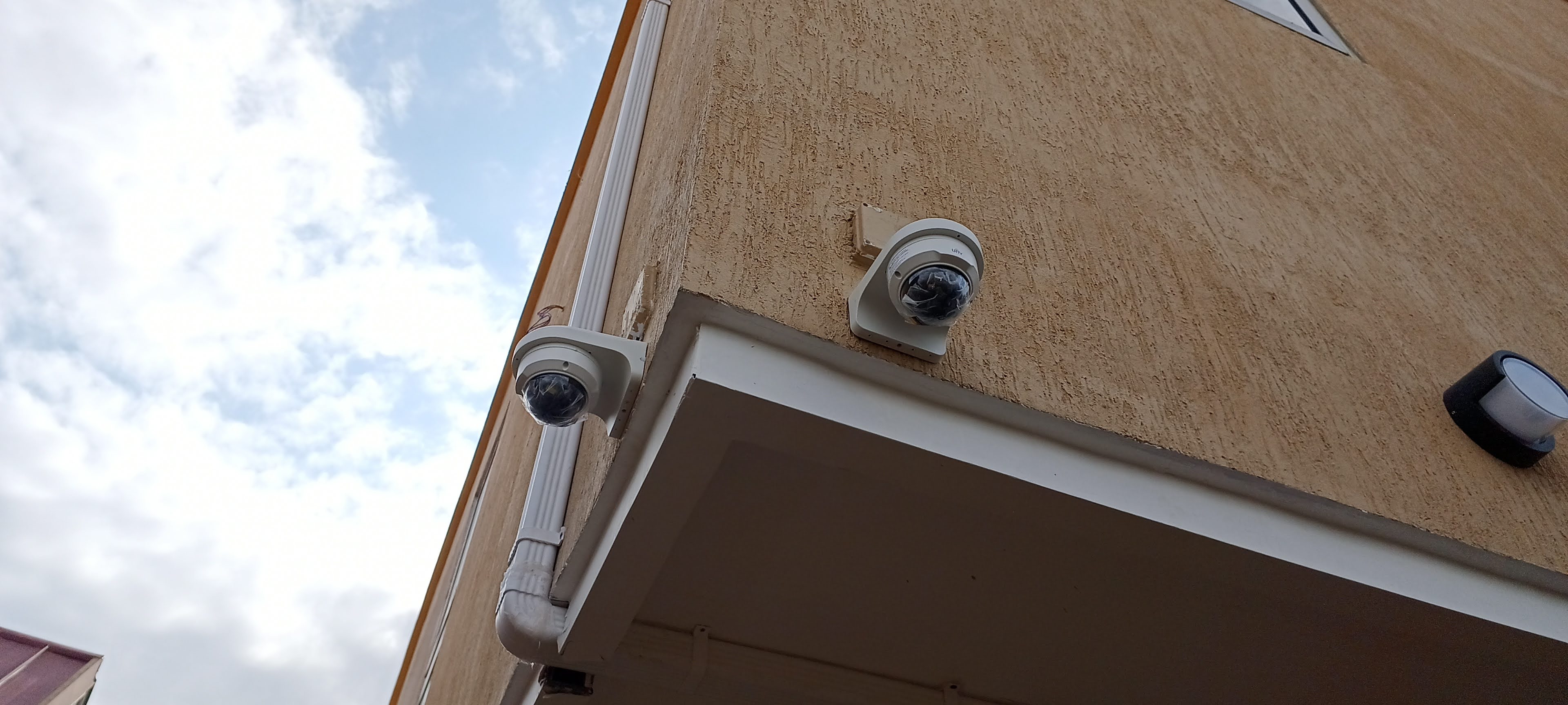 Two dome cameras installed on the exterior of a building
