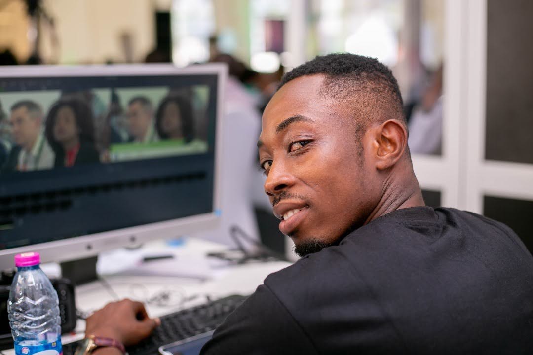 Film editor working at a computer workstation